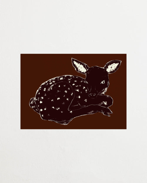Art print with a stylized illustration of a lying deer in a dark tone against a dark brown background, with a minimalist and graphic expression. Styled in a minimalist interior.