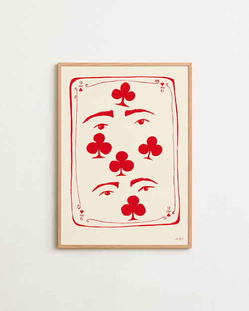 Framed artwork of a playing card design with red symbols on a beige background