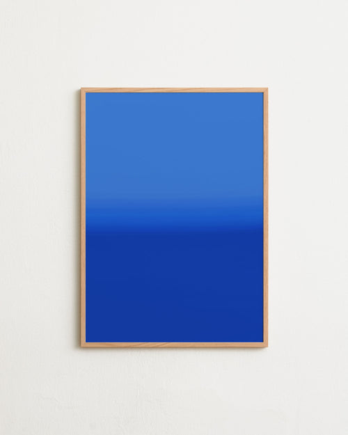 Framed blue artwork on a white wall