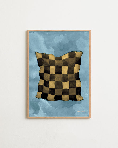 Framed artwork of a checkered pillow on a blue background