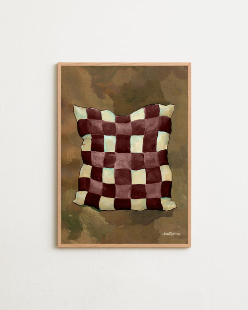 Framed artwork of a checkered pillow on a textured background