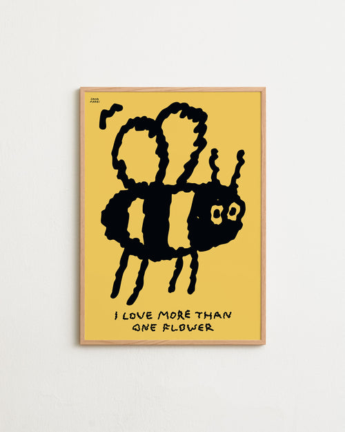 Framed artwork of a black cactus with a face on a yellow background, featuring the text 