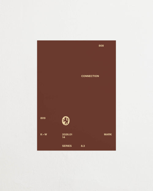 Art print with minimalist, small graphic text elements and a symbol motif in beige against a brown background. Styled in a minimalist interior.