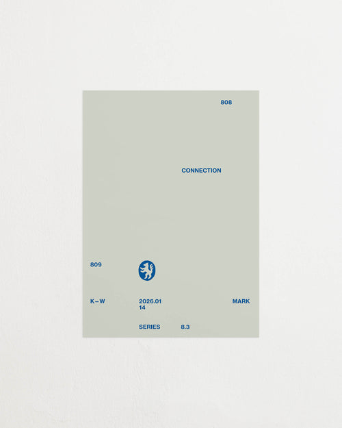 Art print with minimalist, small graphic text elements and a symbol motif in navy blue against a light blue background. Styled in a minimalist interior.