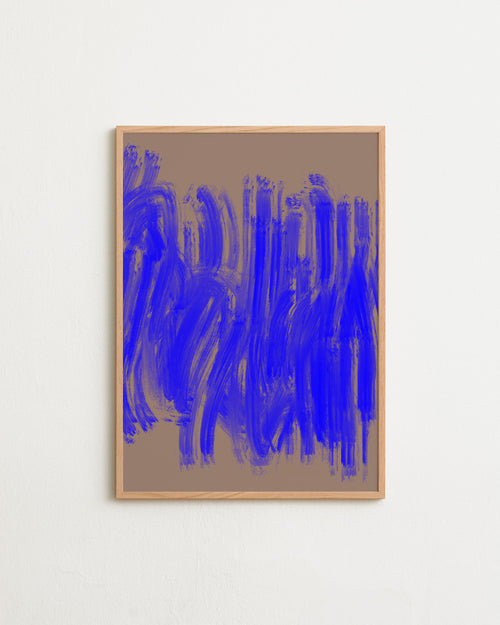 Abstract art print with blue brush strokes in a wooden frame on a beige background