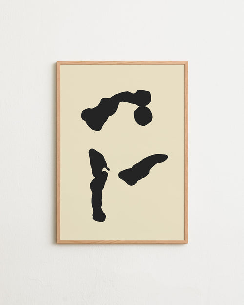 Framed abstract art with black shapes on a beige background