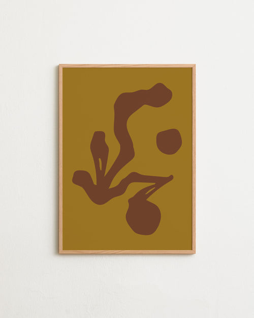 Framed abstract art with brown shapes on a mustard yellow background