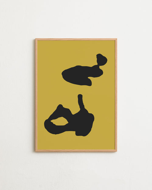 Framed abstract art with black shapes on a yellow background
