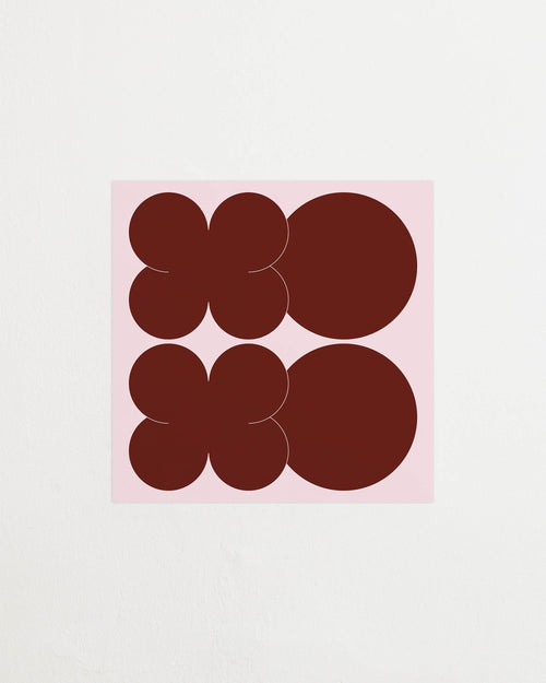 Square-format Art print featuring playful, bold typography of the letters X and O, hugs and kisses, in burgundy against a pink background. Featured against a light background.