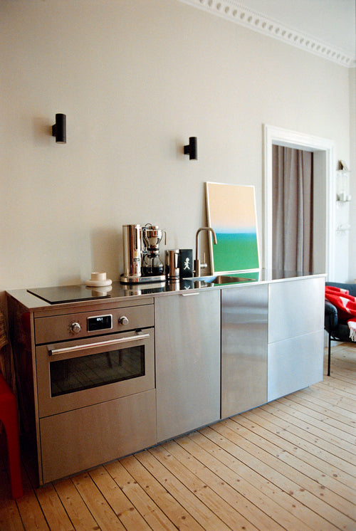 Modern kitchen with stainless steel appliances and wooden flooring